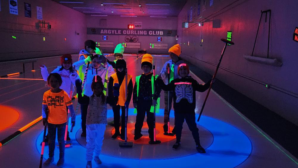 Kids at the Glow Bonspiel under black lights